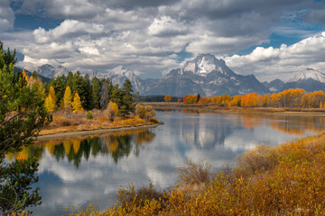 Alpine lake and colorful trees with reflection and mountain landscape