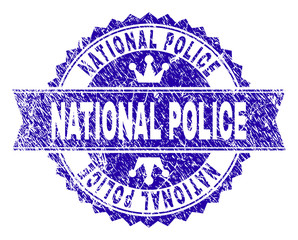 NATIONAL POLICE rosette stamp imprint with grunge style. Designed with round rosette, ribbon and small crowns. Blue vector rubber print of NATIONAL POLICE tag with dust style.