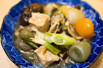 Fototapeta na wymiar Imoni in a dish (Imoni is a type of taro and meat soup eaten traditionally in the autumn in the Northeast region of Japan)