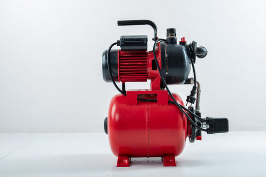 Red surface water pump. White background