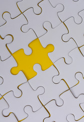 Obraz premium white jigsaw puzzle on yellow background
