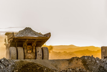 Mining dump trucks transporting Platinum ore for processing