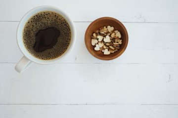 Fresh bubble hot black coffee in pure white ceramic cup on white wooden table, coffee love concept, copy space