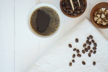 Fresh bubble hot black coffee in pure white ceramic cup on white wooden table, coffee love concept, copy space