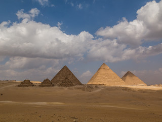 Fototapeta na wymiar Great Pyramids of Egypt on a beautiful day with blue sky and white clouds