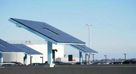 Fototapeta na wymiar solar panels at the parking lot near oil tank