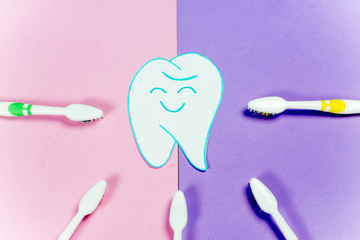 toothbrushes and a toothpaste on a colorful background