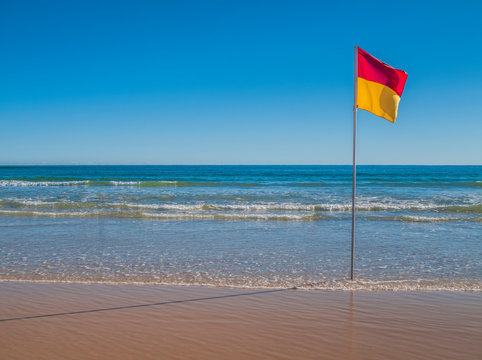 Beach With Red And Yellow Flag Indicating Safe, Patrolled Beach In Australia