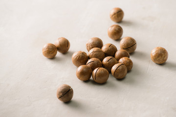 Superfood. Organic macadamia nut on stone background.