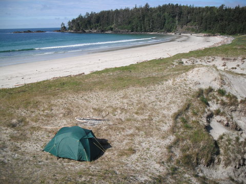 A tent in the sand dunes overlooking Guise Bay in Cape Scott Provincial Park on Vancouver Island. It is a nice warm day and no one else is on the beach. The hike is 13 miles (21km) from the trailhead.