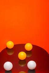 Abstract still life with white and yellow balls on a colored background
