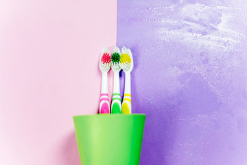 toothbrushes and a toothpaste on a colorful background