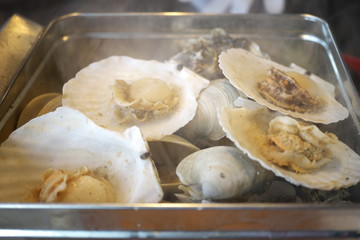 Shizuoka,Japan-December 20, 2018: Typical Japanse cooking, Gangan Yaki. Shellfish are grilled in a tin can.
