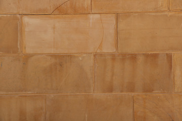 vintage yellow natural stone brick wall closeup