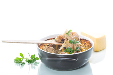 Cauliflower baked with meatballs in cheese sauce