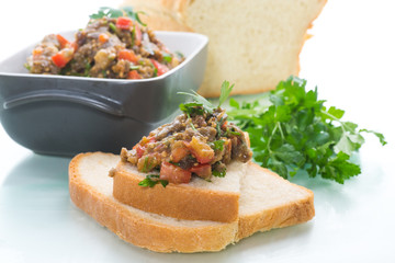 eggplant caviar with tomatoes and a slice of bread