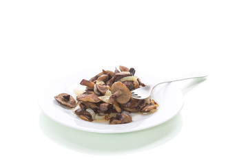 boletus mushrooms fried with onions in a plate