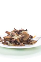 boletus mushrooms fried with onions in a plate