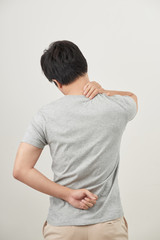Man rubbing his painful back close up. Business man holding his lower back. Pain relief, chiropractic concept
