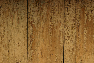 Brown wooden fence with old peeling paint. Textured background with timber planks and cracked paint