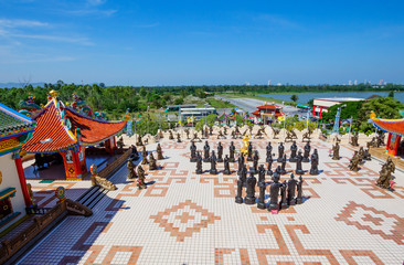 Fototapeta premium Pattaya, Thailand, Chinese temple of Viharn Sien. Playground in front of the temple. On the site in front of the temple built an army of sculptures of Shaolin warriors in combat poses and monks.