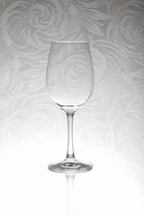 Glass wine glass stands on a blurred background