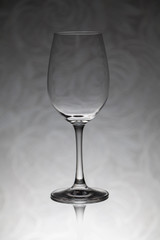 Glass wine glass stands on a blurred background