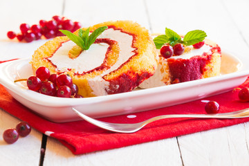 Cake with cream, fresh fruit and mint