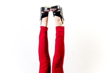 Female legs in red trousers and shoes