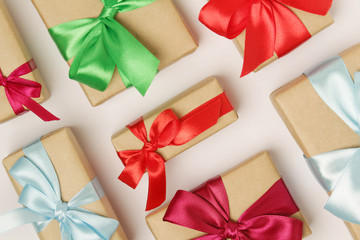 Gifts packed with craft paper and colorful satin ribbons	