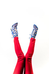 Female legs in red trousers and shoes