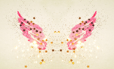 Golden glitter and glittering stars on abstract pink watercolor wings in vintage nostalgic colors.