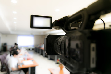 video camera in business conference room recording participants and headphone