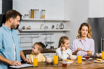 happy family having breakfast at table in kitchen