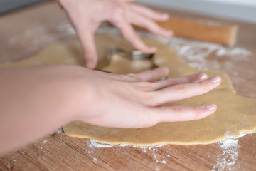 Christmas cookies preparation. Cookies cutter, dough for cookies and rolling pin on the kitchen...