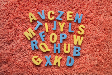 the letters of the alphabet in disorder on a pink background © Карина Желнина