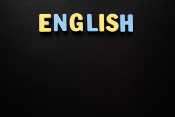 the word English made up of colored letters on a black background