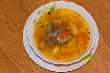 Shurpa - traditional mutton soup in Central Asia on a wooden background