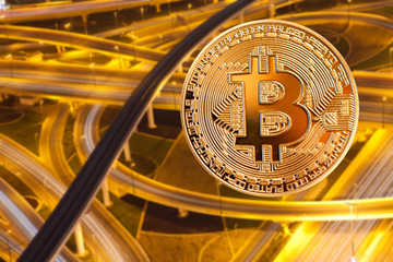 bitcoin and busy traffic in the background - futuristic smart city - cryptocurrency concept