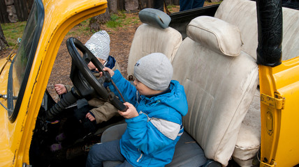 children behind the wheel of a convertible
