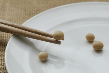 soy bean with chopsticks on plate