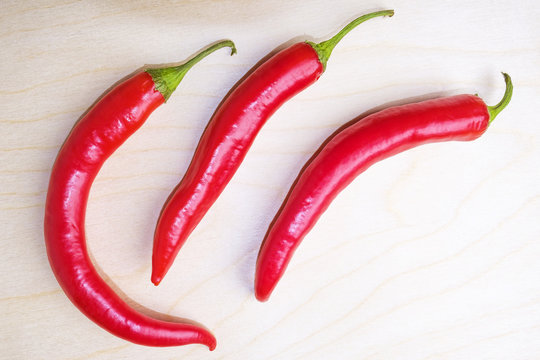 Red fresh hot chili pepper on wooden background