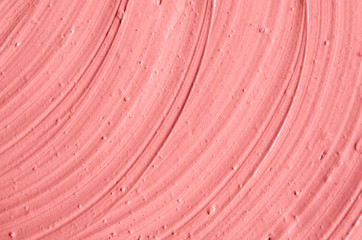 Soft pink cosmetic clay (facial mask, cream) texture close up, selective focus. Abstract background with brush strokes.