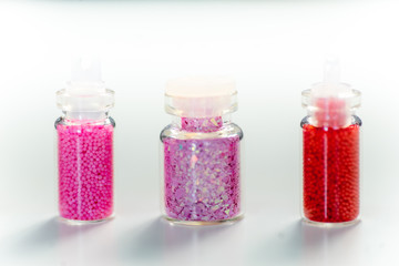 various colorful nail varnish in containers on a table
