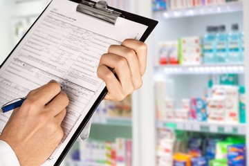 Close-up view of female doctor hands filling patient