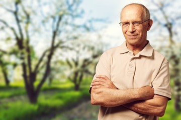 Thoughtful senior man with glasses outdoors