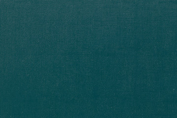 Deep blue-green background with  grid pattern and white dots. Canvas texture of old book cover. Toned image