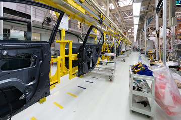 car door on conveyor. Robotic equipment makes Assembly of car. Modern car Assembly at factory