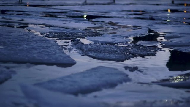 Ice Floating in Calm Lake at Night