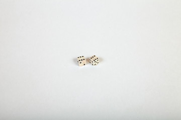 Two very small dice near each other on a large white isolated background with the numbers six on both
